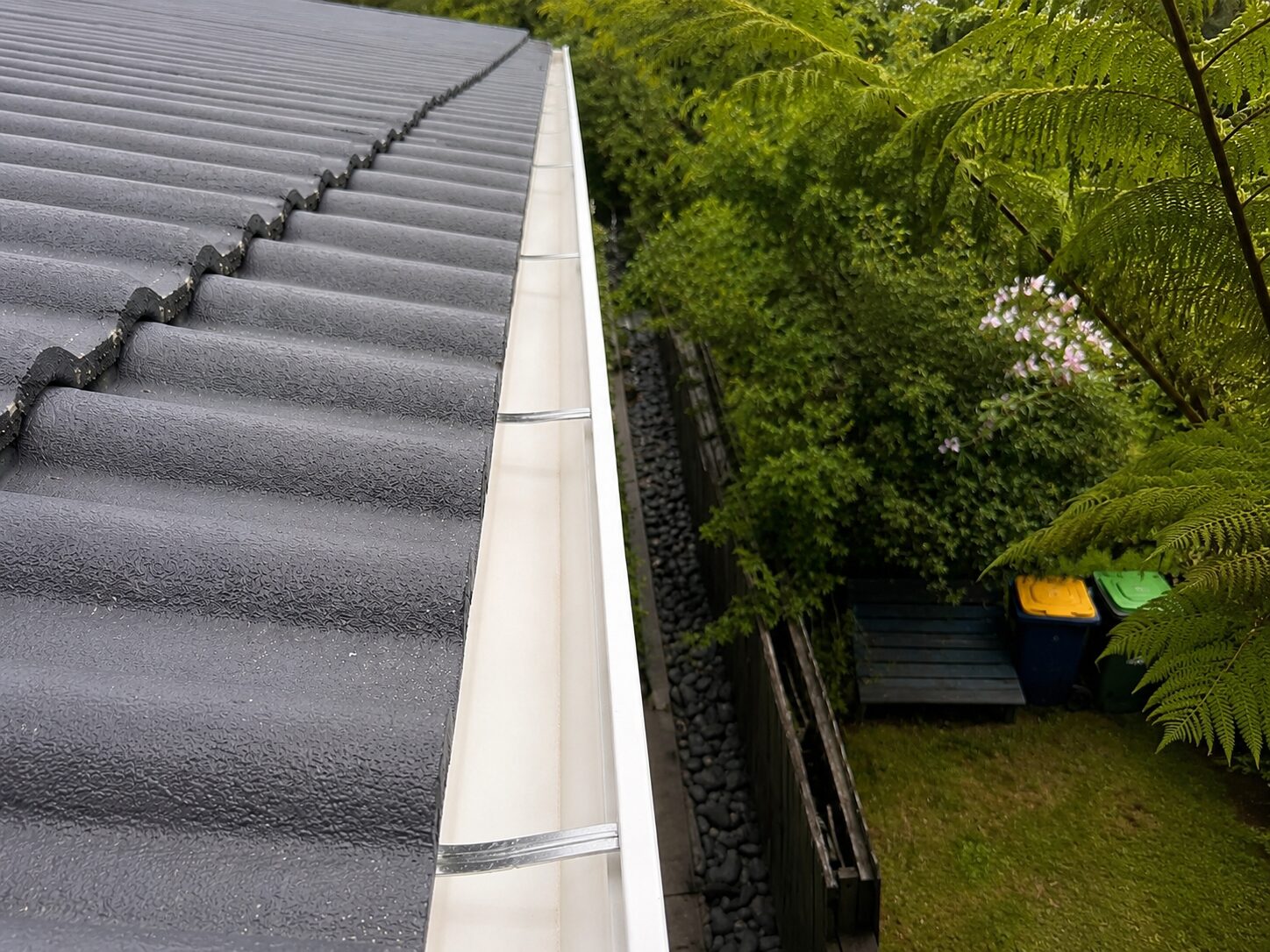 Clean gutter with water flowing freely after cleaning